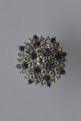 A large circular sapphire and diamond cluster ring