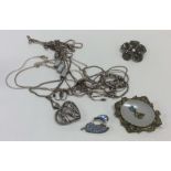 A bag containing silver pendants, brooches and ear