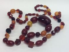 A massive graduated string of amber beads. Approx.