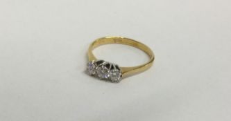 A diamond three stone ring in 18 carat two colour