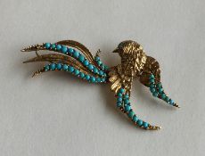 A stylish 9 carat and turquoise brooch in the form