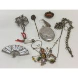 A bag containing silver lockets, brooches and pend