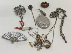 A bag containing silver lockets, brooches and pend