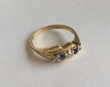 A diamond and sapphire five stone crossover ring i