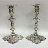 A good pair of George III cast silver candlesticks