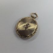 An Antique silver gilt locket with chased decorati