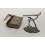 A bag containing silver wine labels, tongs etc. Ap