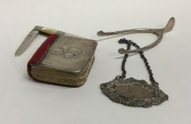 A bag containing silver wine labels, tongs etc. Ap