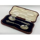 A boxed pair of silver preserve spoons with pierce