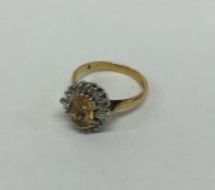 A modern diamond and citrine cluster ring in 18 ca