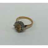 A modern diamond and citrine cluster ring in 18 ca