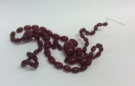 A graduated string of red amber beads with conceal