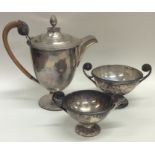 An unusual silver three piece coffee service with wooden handles. Sh