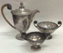 An unusual silver three piece coffee service with wooden handles. Sh