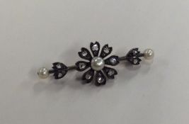 A rose diamond and pearl brooch in the form of a f