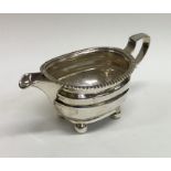 A Georgian silver cream jug on ball feet with gadr