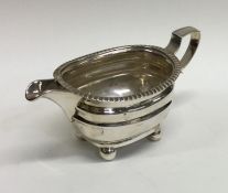 A Georgian silver cream jug on ball feet with gadr