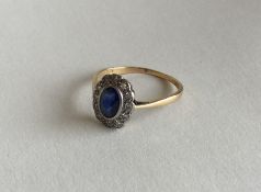 A sapphire and diamond circular cluster ring in tw