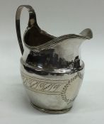 A Georgian silver bright cut cream jug with reeded