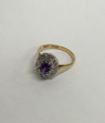 An amethyst and diamond 18 carat cluster ring. App