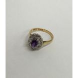 An amethyst and diamond 18 carat cluster ring. App