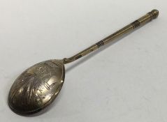 A Russian silver gilt spoon decorated with flowers