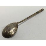 A Russian silver gilt spoon decorated with flowers