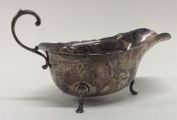 An Edwardian Adams' style silver sauce boat with c