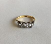 An 18 carat diamond three stone ring in claw mount