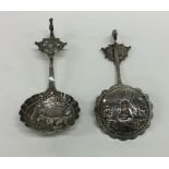 A pair of Continental silver ladles decorated with