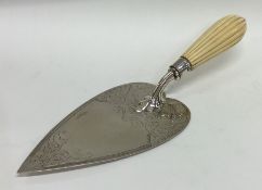 EXETER: A silver engraved trowel with fluted handl