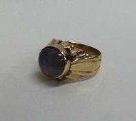 A heavy star sapphire single stone ring in gold fl