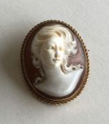 An oval cameo of a lady's head in high relief and