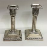 A pair of Edwardian silver candlesticks on stepped