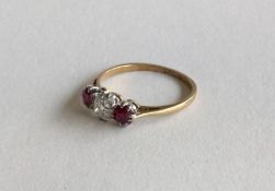 An old cut diamond and ruby three stone ring in 18
