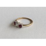 An old cut diamond and ruby three stone ring in 18