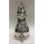 A heavy Continental silver caster with swirl decor