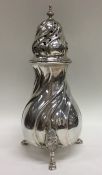 A heavy Continental silver caster with swirl decor