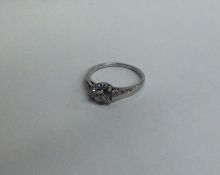 A diamond single stone ring in French claw mount.