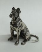 An unusual silver model of a dog in seated positio