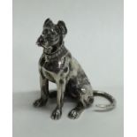 An unusual silver model of a dog in seated positio