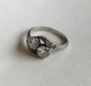 A good diamond two stone crossover ring in platinu