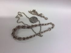 A massive silver necklace together with pendants e