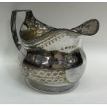 A good Georgian bright cut silver cream jug with r