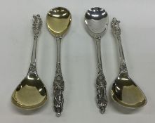 A cased set of four heavy cast apostle top spoons.