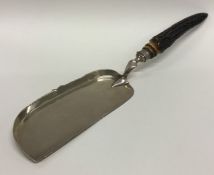 A silver crumb scoop with horn decoration. Sheffie