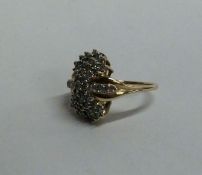 A large 14 carat gold diamond cluster ring in claw