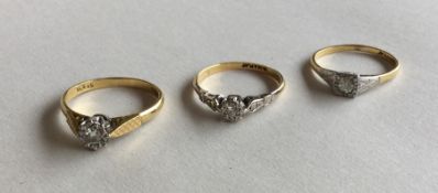 A group of three diamond single stone rings in 18