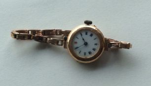 A 9 carat lady's wristwatch on mesh strap. Approx.