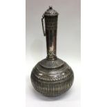 A large Islamic silver ewer with fluted decoration